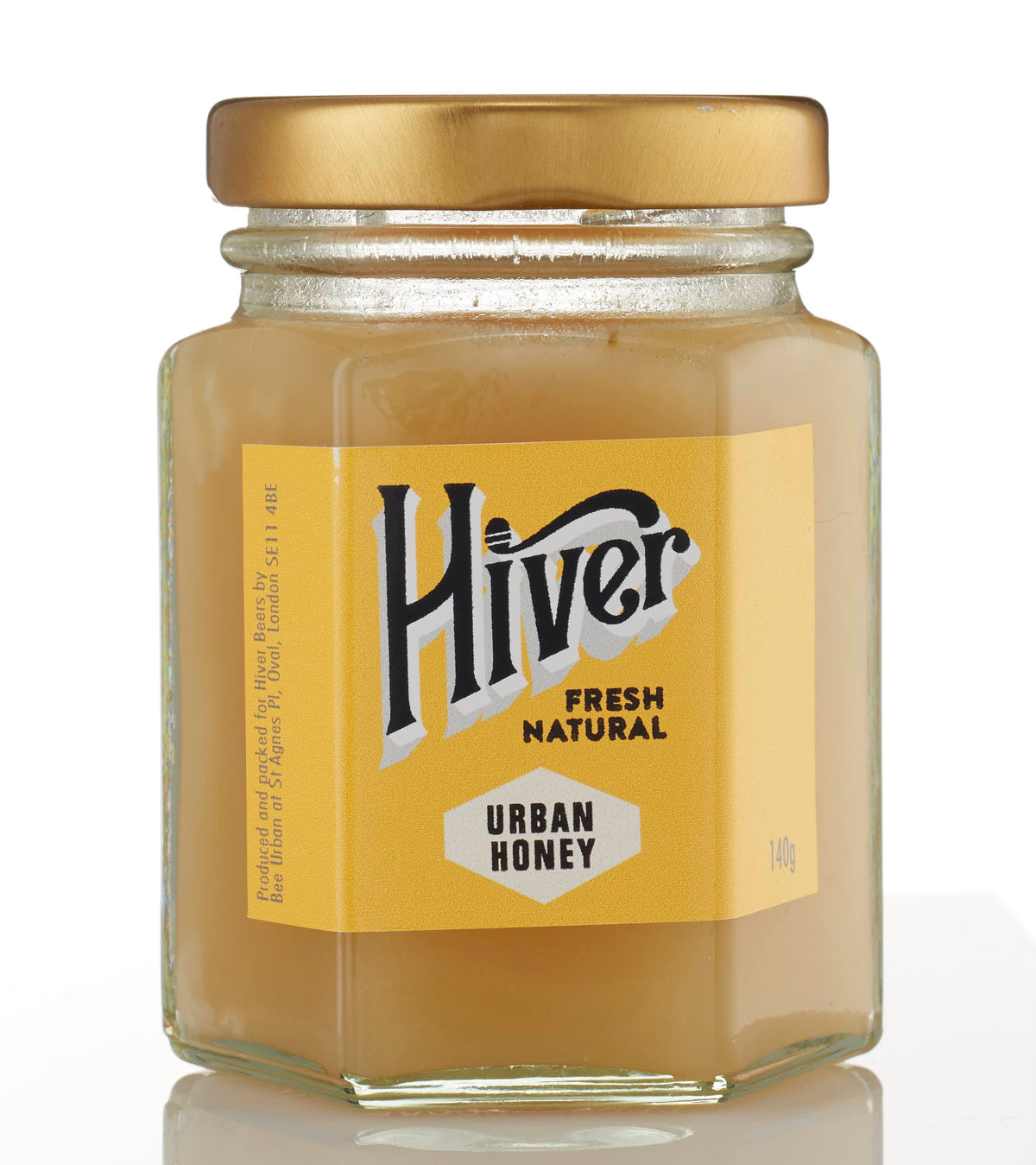 Closed jar of Hiver London Urban Honey with gold lid on a white background