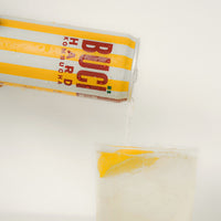 Can of BUCI Hard kombucha being poured into a glass with a wedge of lemon