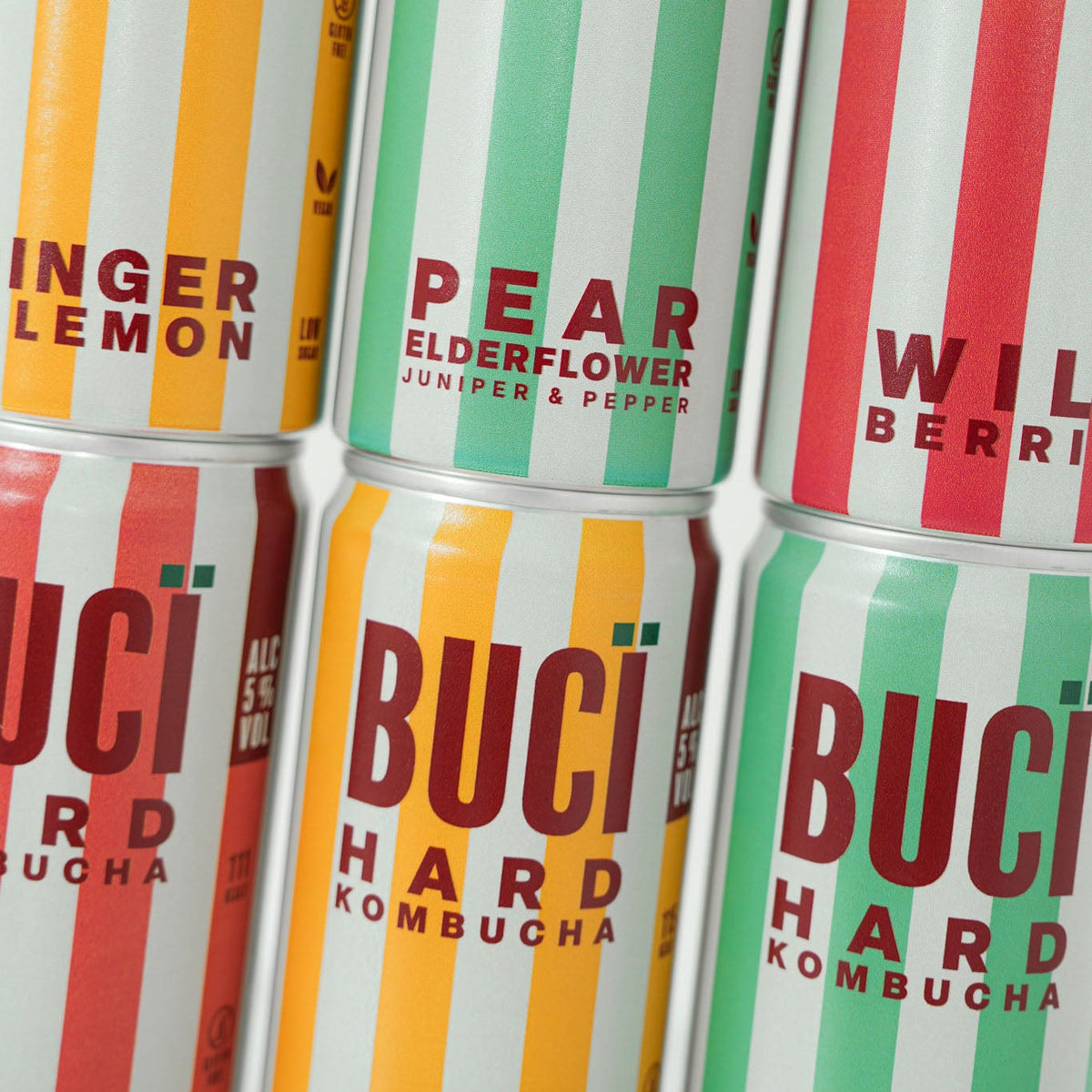 Multiple cans of BUCÏ Hard Kombucha flavours stacked on each other.