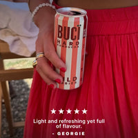 Person in a red dress holding a striped can hard kombucha Buci alcoholic